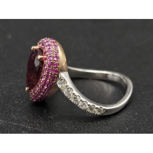 174 - An extraordinary 18 K white gold ring with a central pear cut rubelite  (3 carats appr), surrounded ... 