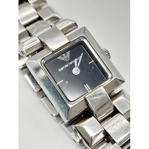 635 - A solid stainless steel |EMPORIO ARMANI ladies watch. Square dial 18 mm, black dial, quartz movement... 