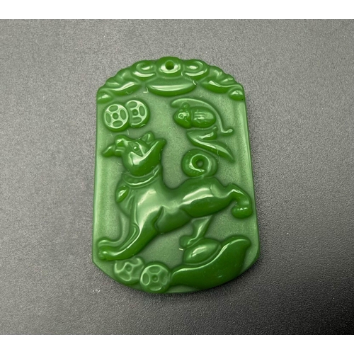 1367 - A Chinese Green Jade Foo Dog Pendant. 4 x 3cm