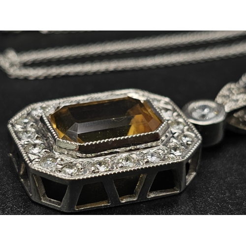 153 - A very nice 18 K white gold pendant with an emerald cut citrine surrounded by diamonds (3 ct. appr.)... 