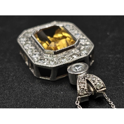 153 - A very nice 18 K white gold pendant with an emerald cut citrine surrounded by diamonds (3 ct. appr.)... 