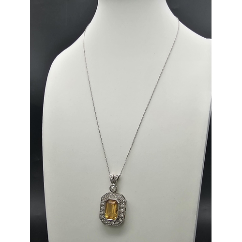 153 - A very nice 18 K white gold pendant with an emerald cut citrine surrounded by diamonds (3 ct. appr.)... 