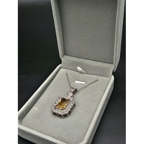 153 - A very nice 18 K white gold pendant with an emerald cut citrine surrounded by diamonds (3 ct. appr.)... 