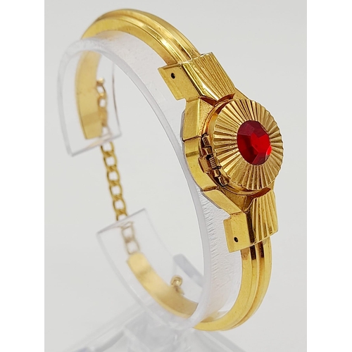 301 - A vintage, richly gilded, CARVEN DELUXE Antimagnetic, ladies, bangle watch with a large, synthetic, ... 