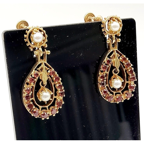 386 - A Pair of Art Deco Style 14K Gold, Garnet and Pearl Drop Earrings. Intricate design with a floating ... 