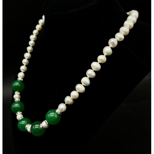 697 - A Cultured Pearl and Green Jade Necklace. 14mm jade beads.
Necklace length - 42cm