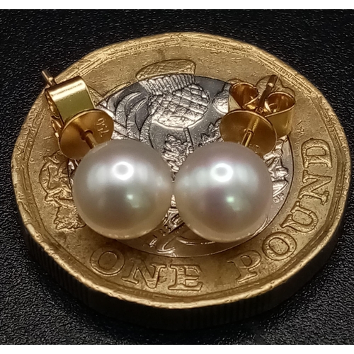 717 - A Pair of 18K Yellow Gold South Sea Pearl Stud Earrings. 1.3g total weight.