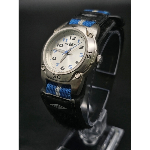 741 - An UMBRO watch. Stainless steel case 33 mm, silver tone dial with black and blue numerals, quartz mo... 