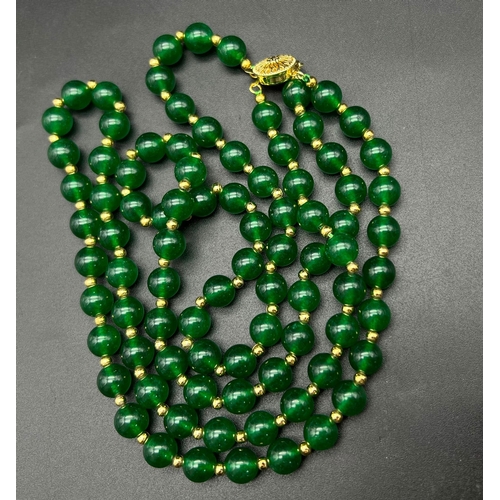 1045 - A Two-Row Jade Bead Necklace with Gilded Spacers and Clasp. 42cm. Jade beads - 8mm.