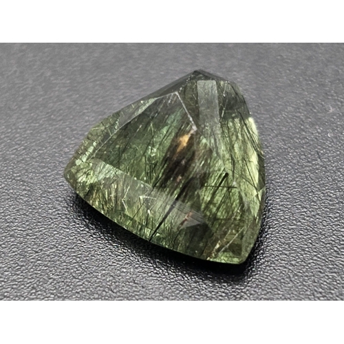 1133 - An 8.74ct Rutiliated Pakistan Peridot Gemstone. GGI Certified Origin. Curved Trillion Cut.