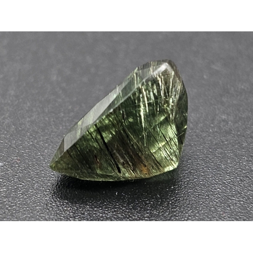 1133 - An 8.74ct Rutiliated Pakistan Peridot Gemstone. GGI Certified Origin. Curved Trillion Cut.