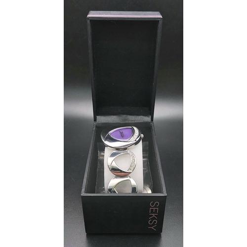 1169 - A stainless steel SECONDA SEKSY ladies watch. 33 mm case with triangular purple dial and silver tone... 