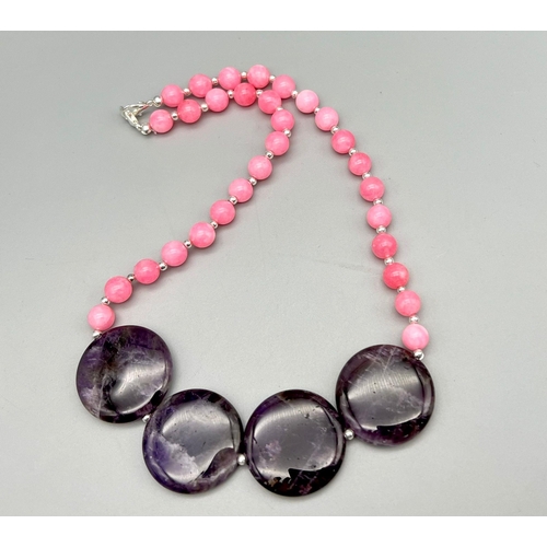 450 - A Pink Jade and Amethyst Necklace. Small pink jade beads-8mm with four large amethyst discs - 25mm. ... 