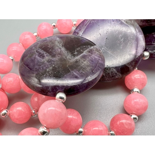 450 - A Pink Jade and Amethyst Necklace. Small pink jade beads-8mm with four large amethyst discs - 25mm. ... 