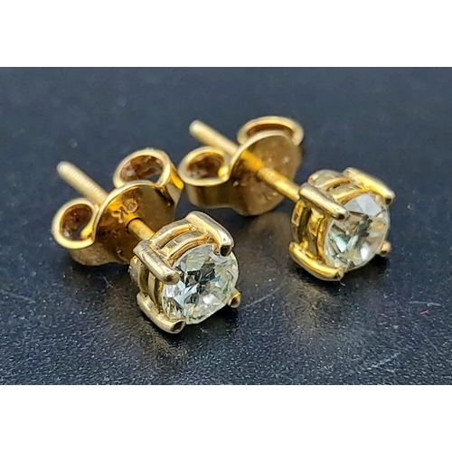 600 - A 9 K yellow gold pair of diamond (total 1.10 carats) stud earrings with screw butterflies. Total we... 