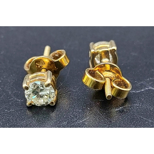 600 - A 9 K yellow gold pair of diamond (total 1.10 carats) stud earrings with screw butterflies. Total we... 