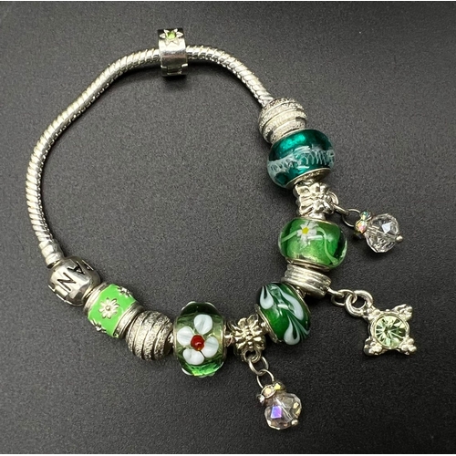 807 - SILVER BRACELET marked PANDORA Having Silver Sided charms and others in shades of green and silver. ... 