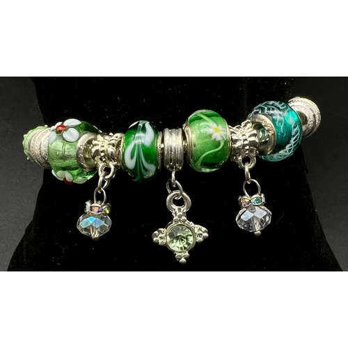 807 - SILVER BRACELET marked PANDORA Having Silver Sided charms and others in shades of green and silver. ... 