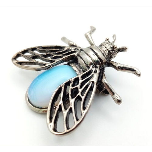 1371 - An Opalite Bee Brooch. Set in white metal. Wingspan - 3.5cm