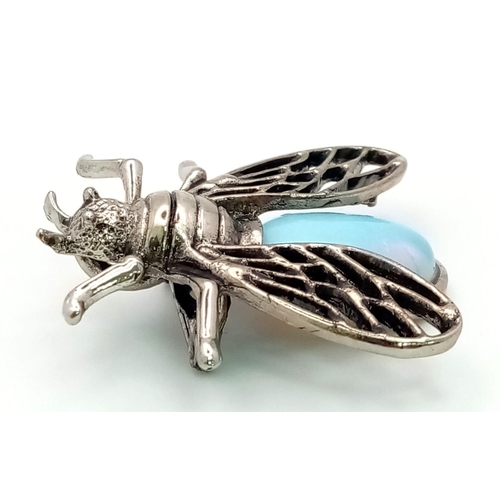 1371 - An Opalite Bee Brooch. Set in white metal. Wingspan - 3.5cm