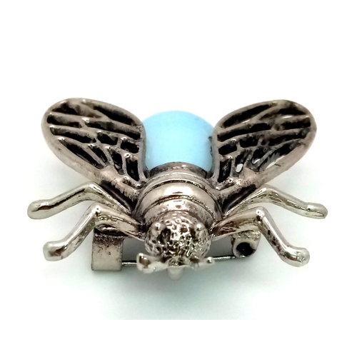 1371 - An Opalite Bee Brooch. Set in white metal. Wingspan - 3.5cm