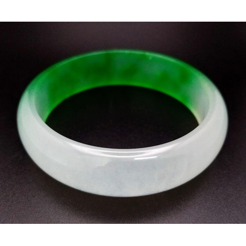 457 - A Lovely Chinese Green and White Jade Quality Bangle. 6cm inner diameter. 2cm width.