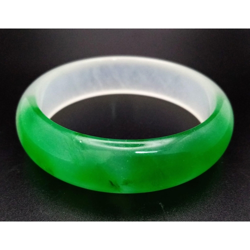 457 - A Lovely Chinese Green and White Jade Quality Bangle. 6cm inner diameter. 2cm width.