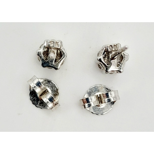 1090 - A Pair of 9K White Gold Diamond Stud Earrings. Two clean white clusters. 1.3g total weight. Comes in... 