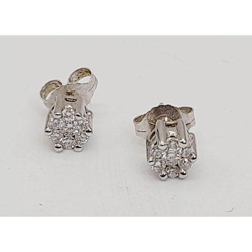 1090 - A Pair of 9K White Gold Diamond Stud Earrings. Two clean white clusters. 1.3g total weight. Comes in... 