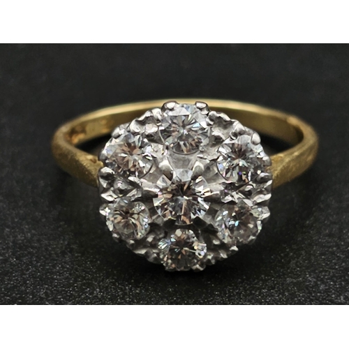 289 - An 18K Yellow Gold and Platinum Diamond Ring. Seven near white diamonds create the perfect flower. 1... 