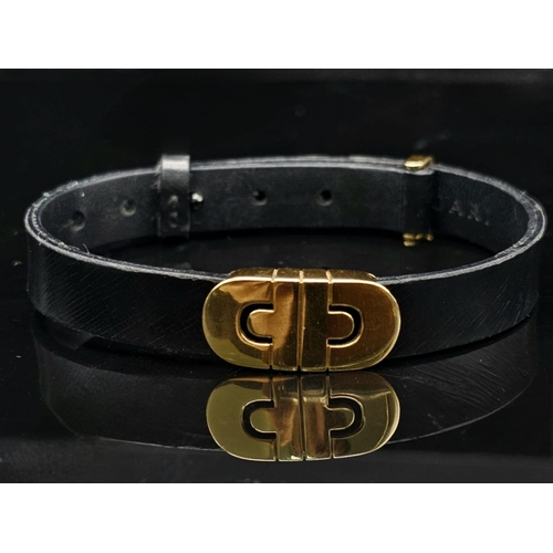 101 - A Bulgari Perentesi 18K Gold and Black Leather Bracelet. Comes in a Bulgari presentation case (worn ... 