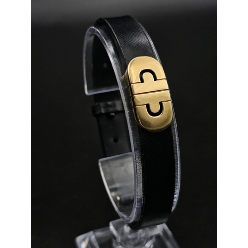 101 - A Bulgari Perentesi 18K Gold and Black Leather Bracelet. Comes in a Bulgari presentation case (worn ... 