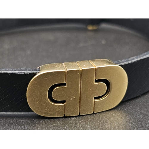 101 - A Bulgari Perentesi 18K Gold and Black Leather Bracelet. Comes in a Bulgari presentation case (worn ... 