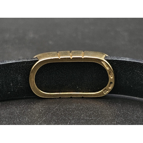 101 - A Bulgari Perentesi 18K Gold and Black Leather Bracelet. Comes in a Bulgari presentation case (worn ... 