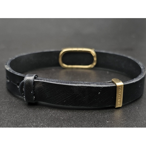 101 - A Bulgari Perentesi 18K Gold and Black Leather Bracelet. Comes in a Bulgari presentation case (worn ... 