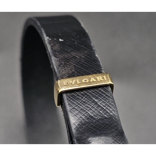 101 - A Bulgari Perentesi 18K Gold and Black Leather Bracelet. Comes in a Bulgari presentation case (worn ... 