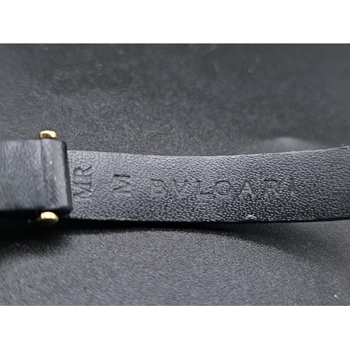 101 - A Bulgari Perentesi 18K Gold and Black Leather Bracelet. Comes in a Bulgari presentation case (worn ... 