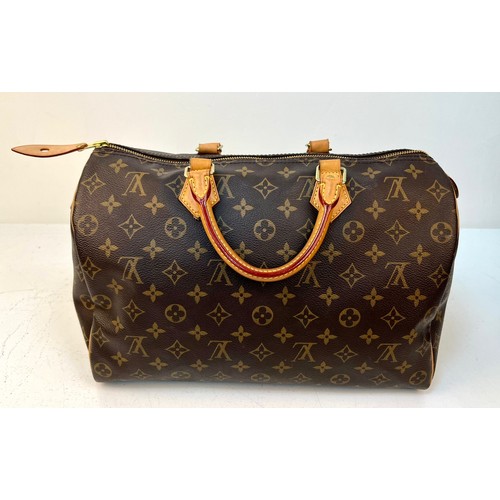 108 - A Louis Vuitton Monogram Ladies Speedy Bag. Brown LV canvas with brown leather handles and gold-tone... 