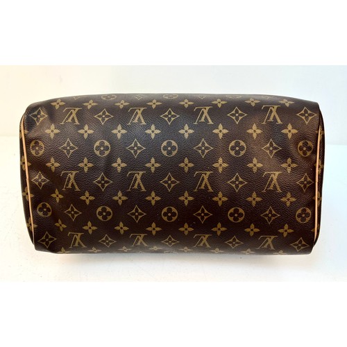 108 - A Louis Vuitton Monogram Ladies Speedy Bag. Brown LV canvas with brown leather handles and gold-tone... 