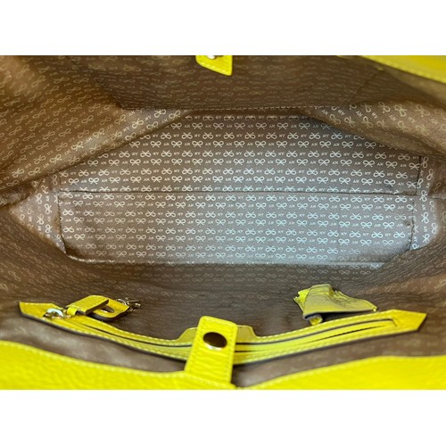 1157 - An Anya Hindmarch Patent Yellow Leather and Straw Small Tote Bag. Exterior magnetic pocket. Textile ... 