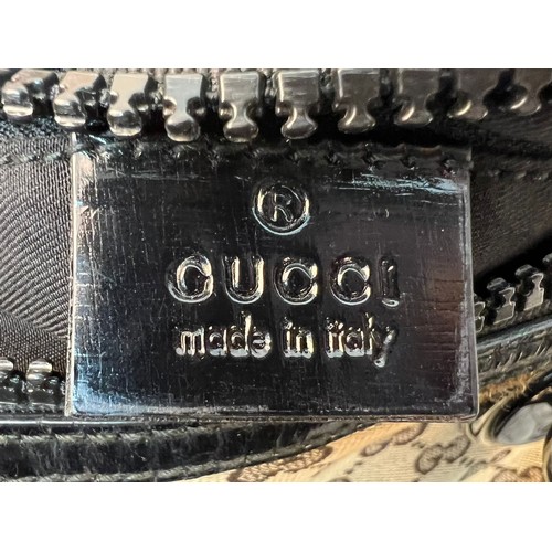 984 - A Gucci Abbey Handbag. Monogram beige cotton exterior with black leather trim. Gucci logo black disc... 