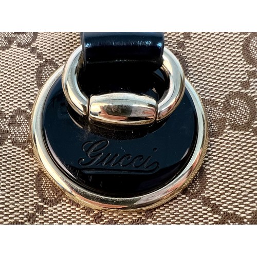 984 - A Gucci Abbey Handbag. Monogram beige cotton exterior with black leather trim. Gucci logo black disc... 