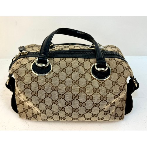 984 - A Gucci Abbey Handbag. Monogram beige cotton exterior with black leather trim. Gucci logo black disc... 