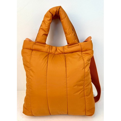 529 - A Kenzo Orange Costanza Puff Bag. Clip top button opening.
Shoulder strap. Dustcover. Interior zippe... 