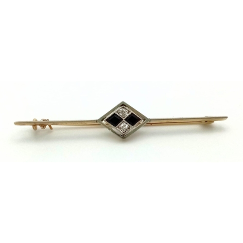 338 - An Art Deco Diamond and Onyx Brooch in 18K Gold and Platinum. 5.5cm. 3.75g total weight.