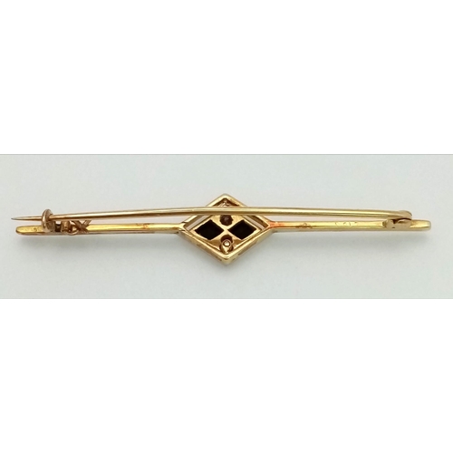 338 - An Art Deco Diamond and Onyx Brooch in 18K Gold and Platinum. 5.5cm. 3.75g total weight.