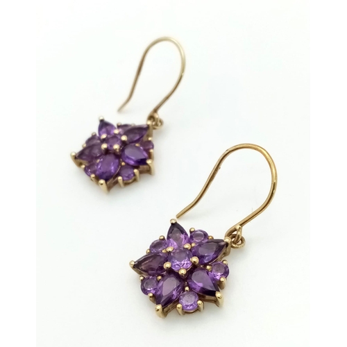 982 - A Pair of Fine Amethyst Star Shaped Cluster Drop Earrings Set in 9K Yellow Gold. 2.43g total weight.