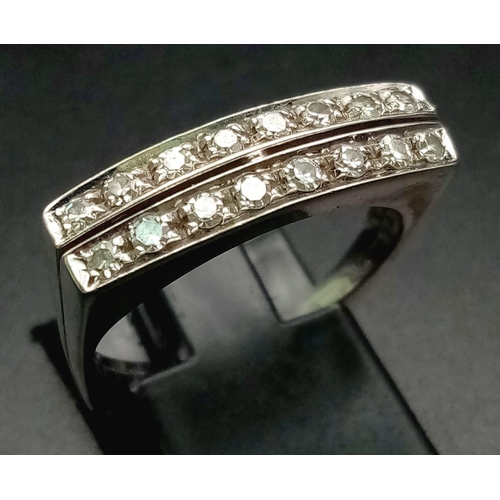 1136 - An 18 K white gold ring with two bands of white sapphires. Ring size: O, weight: 4.6 g.