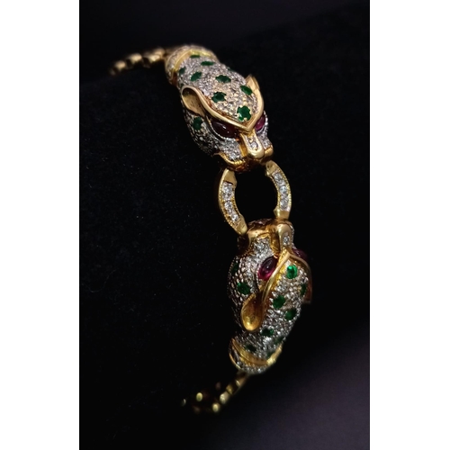 55 - A wonderful 18 K yellow gold designer style PANTHER bracelet with emeralds and diamonds and ruby eye... 