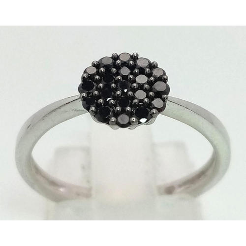 882 - 9K WHITE GOLD BLACK DIAMOND SET CLUSTER RING. TOTAL WEIGHT 2.1G. SIZE N